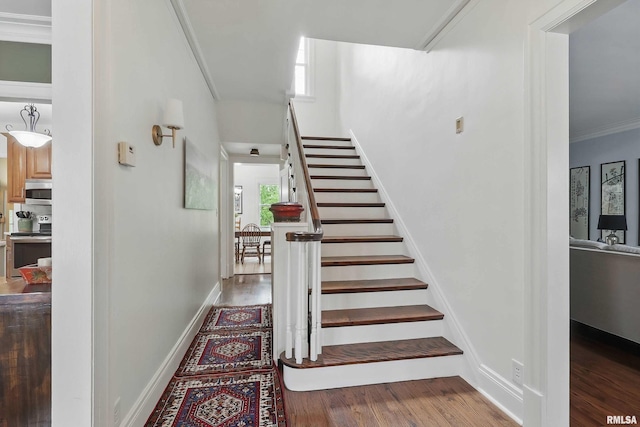 923 22nd St, Moline, IL 61265 - staircase featuring wood finished floors, crown molding, and baseboards
