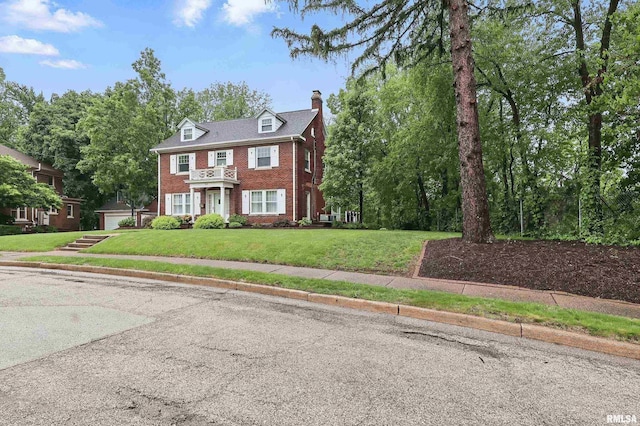 923 22nd St, Moline, IL 61265 - colonial inspired home featuring brick siding, a chimney, a front lawn, and a garage