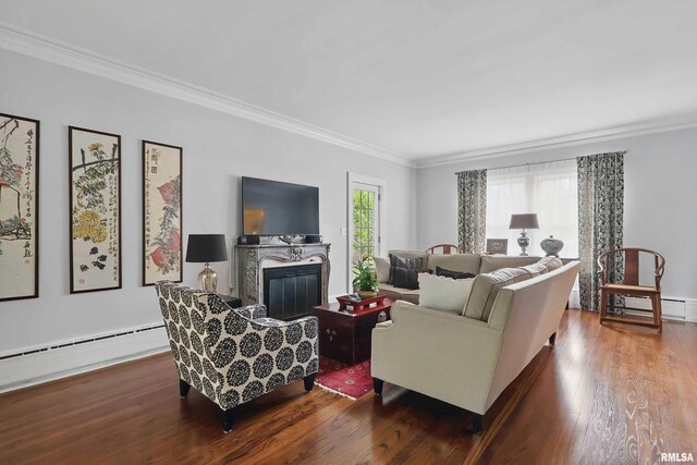 923 22nd St, Moline, IL 61265 - living area featuring wood finished floors, crown molding, a baseboard heating unit, a glass covered fireplace, and a baseboard radiator