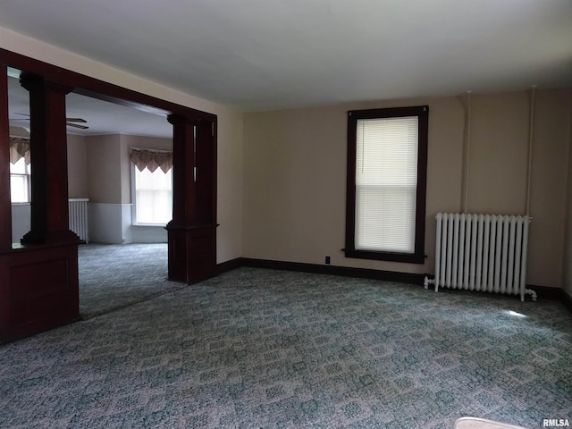 1916 E 13th St, Davenport, IA 52803 - carpeted empty room with radiator heating unit and ornate columns