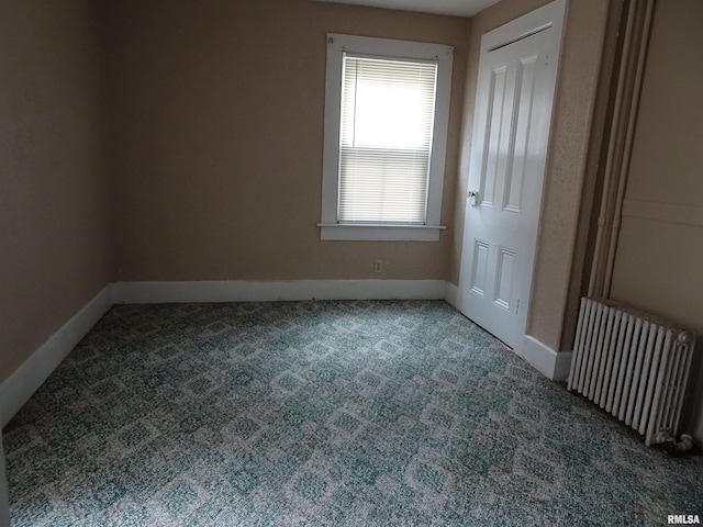 1916 E 13th St, Davenport, IA 52803 - unfurnished bedroom featuring radiator heating unit, carpet, and baseboards