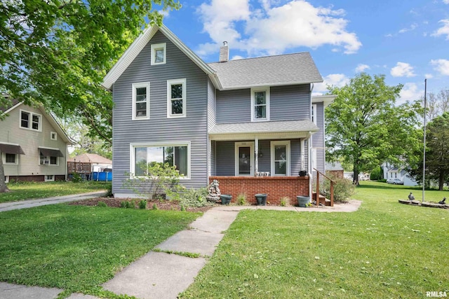 503 SW 4th Ave, Galva, IL 61434 - traditional-style house with a porch, a front lawn, a chimney, and a shingled roof