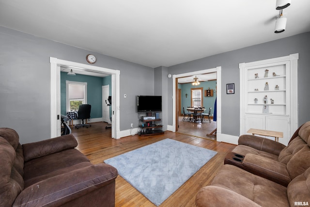 503 SW 4th Ave, Galva, IL 61434 - living room featuring plenty of natural light, a ceiling fan, wood finished floors, and baseboards