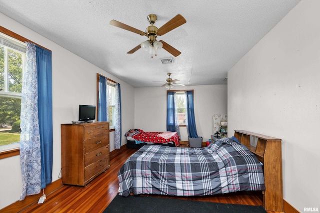 503 SW 4th Ave, Galva, IL 61434 - bedroom featuring a textured ceiling, wood finished floors, and a ceiling fan