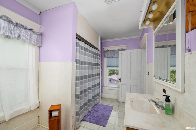 503 SW 4th Ave, Galva, IL 61434 - bathroom with vanity, tile walls, curtained shower, and a wainscoted wall