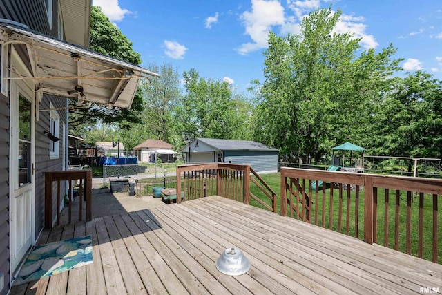 503 SW 4th Ave, Galva, IL 61434 - wooden deck featuring a playground, an outbuilding, and view of scattered trees
