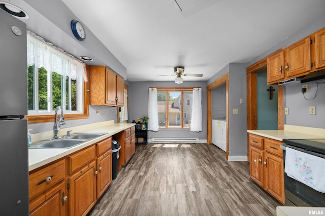 503 SW 4th Ave, Galva, IL 61434 - kitchen featuring a sink, a baseboard radiator, light countertops, and appliances with stainless steel finishes