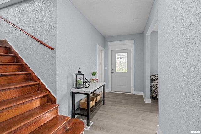 1312 Ripley St, Davenport, IA 52803 - entryway featuring a textured wall, wood finished floors, stairway, and baseboards
