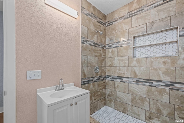 1312 Ripley St, Davenport, IA 52803 - full bath featuring tiled shower, a textured wall, and vanity