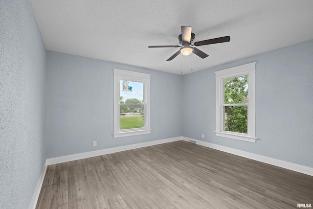 1312 Ripley St, Davenport, IA 52803 - spare room featuring wood finished floors, baseboards, ceiling fan, and a textured ceiling