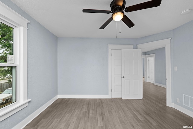 1312 Ripley St, Davenport, IA 52803 - unfurnished bedroom with baseboards, wood finished floors, and ceiling fan