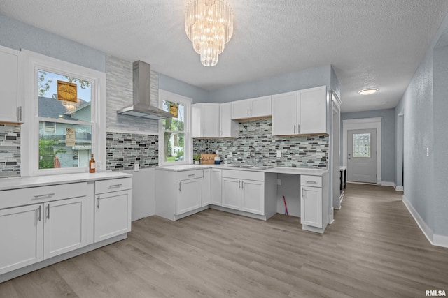 1312 Ripley St, Davenport, IA 52803 - kitchen with wall chimney exhaust hood, a sink, tasteful backsplash, a textured ceiling, and a chandelier