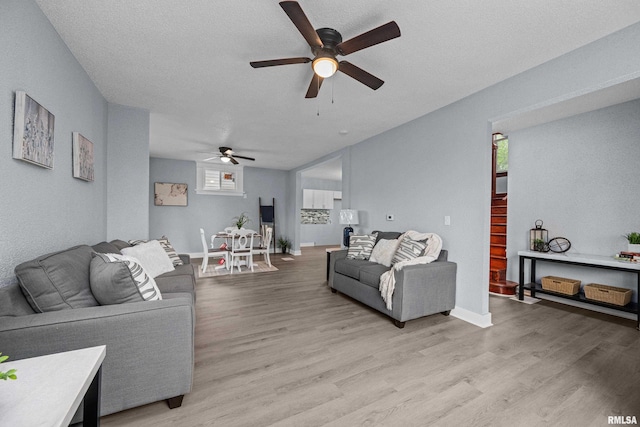 1312 Ripley St, Davenport, IA 52803 - living room featuring a ceiling fan, light wood-type flooring, and baseboards