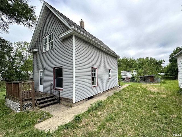 116 W 13th St, Kewanee, IL 61443 - back of property featuring a lawn, a chimney, and a deck