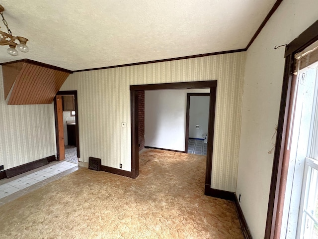 116 W 13th St, Kewanee, IL 61443 - carpeted empty room with ornamental molding, a textured ceiling, and baseboards