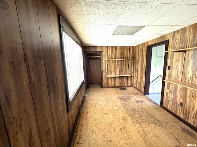 116 W 13th St, Kewanee, IL 61443 - unfurnished room featuring wooden walls, a paneled ceiling, and baseboards