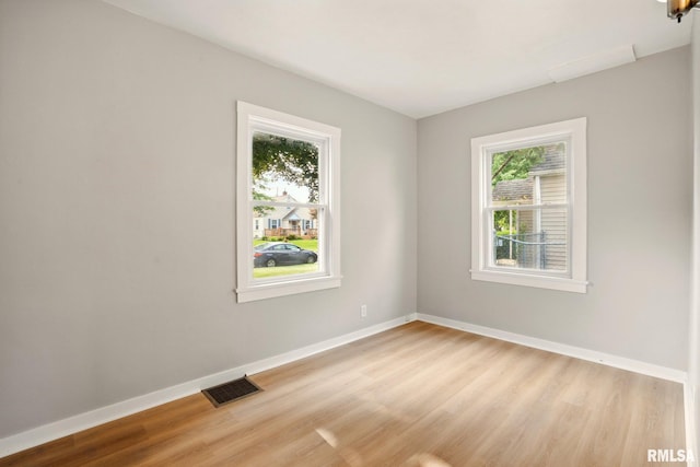 2121 4th St, Moline, IL 61265 - unfurnished room with plenty of natural light, light wood-style floors, and baseboards