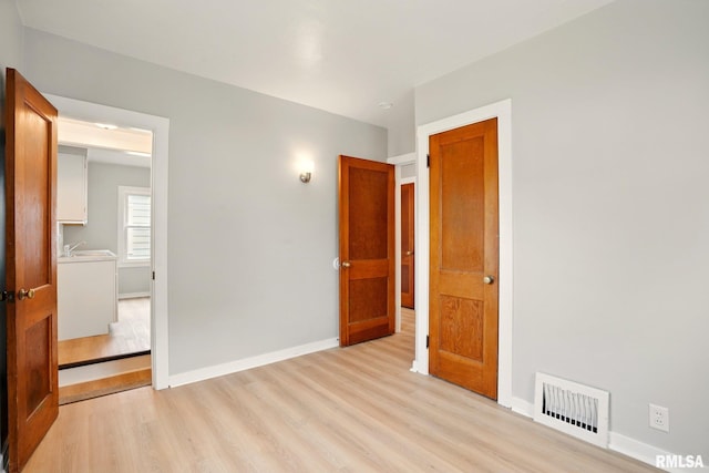 2121 4th St, Moline, IL 61265 - unfurnished bedroom with light wood-style flooring and baseboards