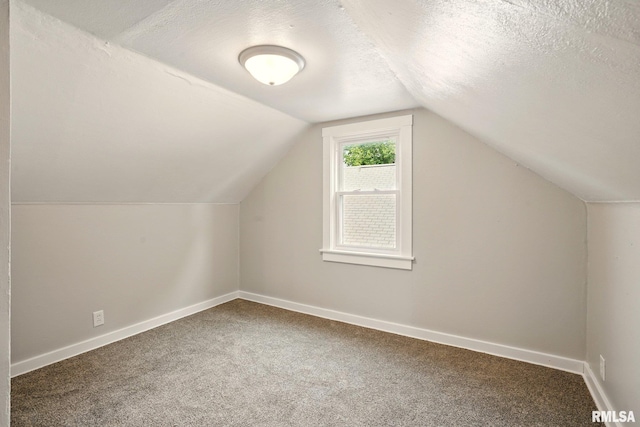 2121 4th St, Moline, IL 61265 - bonus room with carpet flooring, vaulted ceiling, baseboards, and a textured ceiling