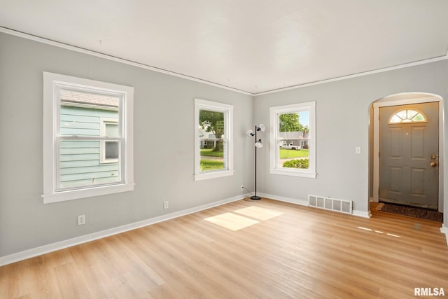 2121 4th St, Moline, IL 61265 - empty room with wood finished floors, arched walkways, baseboards, and ornamental molding
