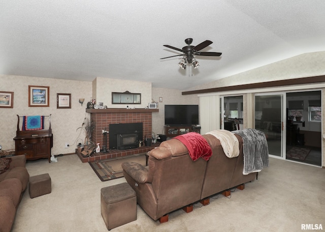 2015 N Zenith Ave, Davenport, IA 52804 - living area featuring carpet floors, vaulted ceiling, a ceiling fan, a textured ceiling, and a tile fireplace