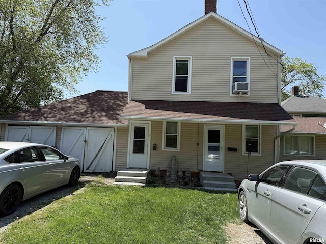 105-109 NE 5th Ave, Aledo, IL 61231 - view of front of house with a front lawn, a chimney, and a shingled roof