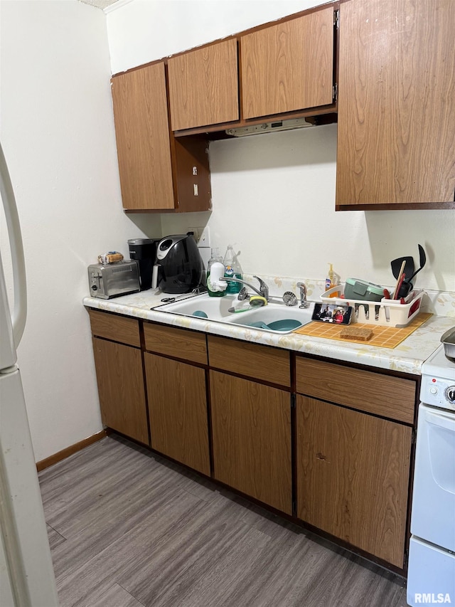 105-109 NE 5th Ave, Aledo, IL 61231 - kitchen with a sink, wood finished floors, light countertops, white appliances, and baseboards