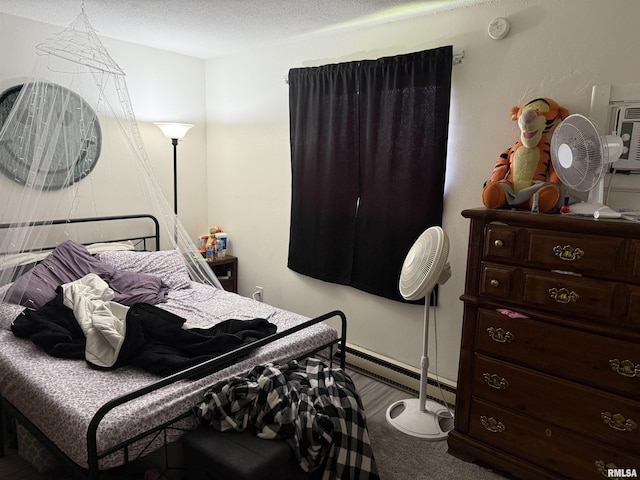 105-109 NE 5th Ave, Aledo, IL 61231 - bedroom featuring carpet floors, a textured ceiling, baseboards, and baseboard heating
