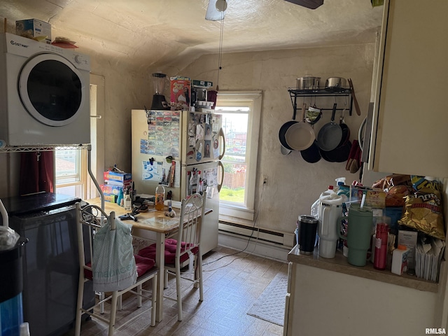 105-109 NE 5th Ave, Aledo, IL 61231 - kitchen with stacked washer / drying machine, a baseboard heating unit, freestanding refrigerator, lofted ceiling, and light floors