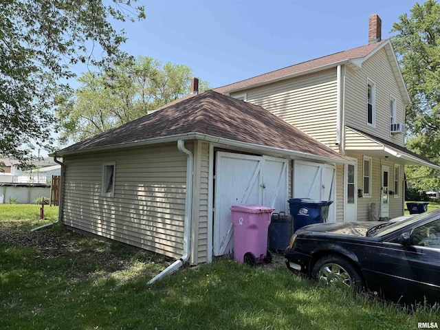 105-109 NE 5th Ave, Aledo, IL 61231 - view of property exterior with a chimney, a shingled roof, and cooling unit