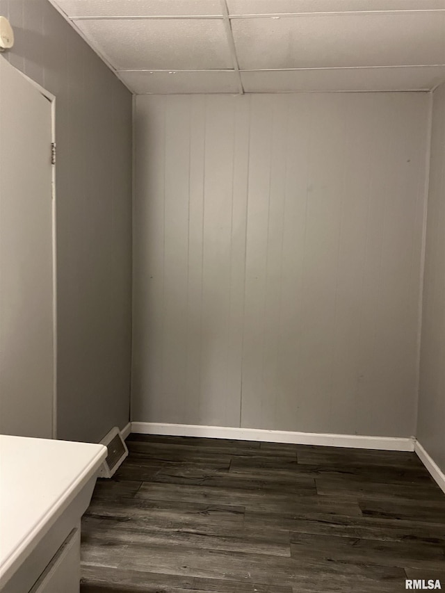 105-109 NE 5th Ave, Aledo, IL 61231 - empty room featuring baseboards, dark wood finished floors, and a drop ceiling