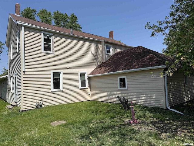 105-109 NE 5th Ave, Aledo, IL 61231 - rear view of property featuring a chimney and a yard