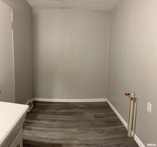 105-109 NE 5th Ave, Aledo, IL 61231 - spare room featuring dark wood-style floors, baseboards, and wood walls
