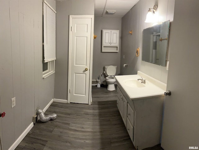 105-109 NE 5th Ave, Aledo, IL 61231 - bathroom with baseboards, vanity, wood finished floors, toilet, and a paneled ceiling