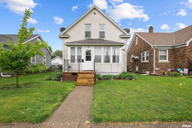 540 15th Ave, East Moline, IL 61244 - view of front facade with a front yard, stucco siding, brick siding, and a chimney