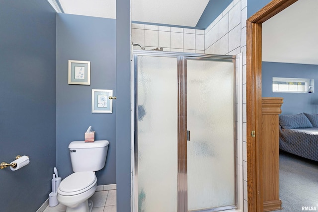 22867 Great River Rd, Le Claire, IA 52753 - ensuite bathroom featuring toilet, a stall shower, tile patterned floors, and baseboards