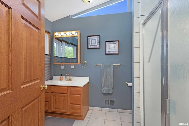 22867 Great River Rd, Le Claire, IA 52753 - full bathroom with vaulted ceiling, tile patterned floors, vanity, and a shower with shower door