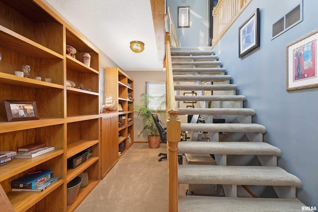 22867 Great River Rd, Le Claire, IA 52753 - staircase featuring carpet floors