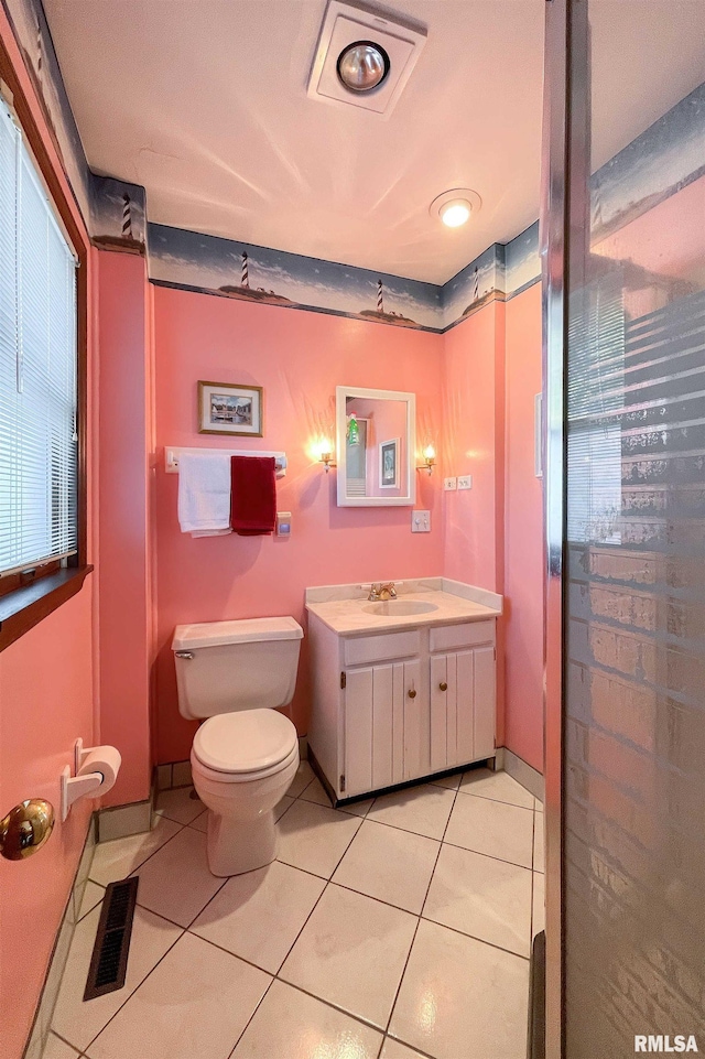 22867 Great River Rd, Le Claire, IA 52753 - bathroom with toilet, vanity, tile patterned floors, and healthy amount of natural light