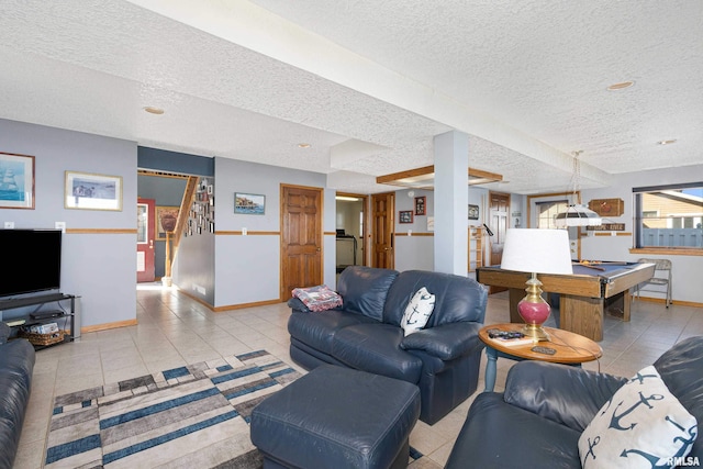 22867 Great River Rd, Le Claire, IA 52753 - living room featuring a textured ceiling, baseboards, stairs, billiards table, and light tile patterned flooring
