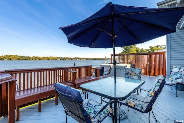 22867 Great River Rd, Le Claire, IA 52753 - wooden terrace with outdoor dining area and a water view