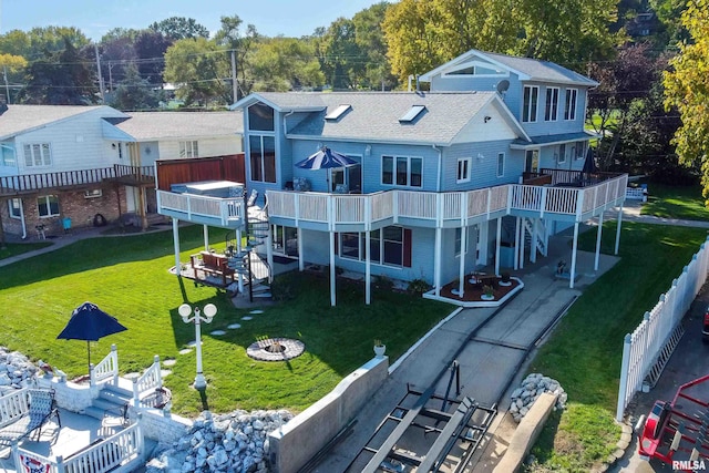 22867 Great River Rd, Le Claire, IA 52753 - back of house featuring an outdoor fire pit, a deck, a yard, roof with shingles, and stairway