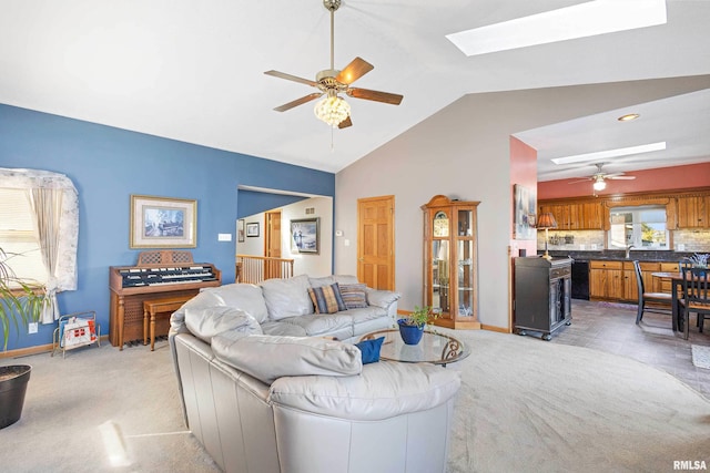 22867 Great River Rd, Le Claire, IA 52753 - living area with a skylight, a ceiling fan, lofted ceiling, light carpet, and baseboards