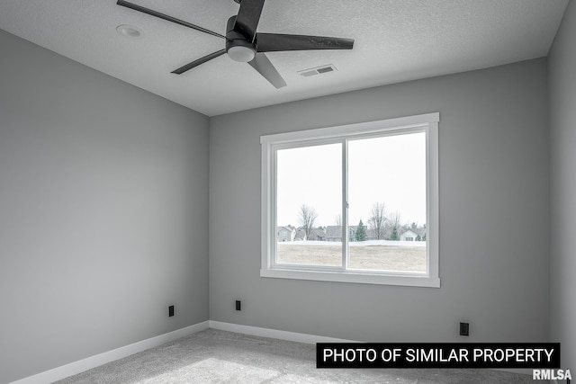1816 E 59th Ct, Davenport, IA 52807 - empty room with ceiling fan, carpet floors, baseboards, and a textured ceiling