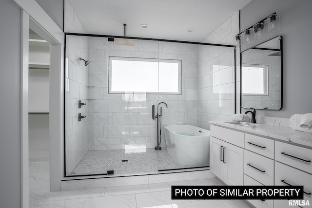 1816 E 59th Ct, Davenport, IA 52807 - bathroom with marble finish flooring, a shower stall, healthy amount of natural light, and a freestanding tub