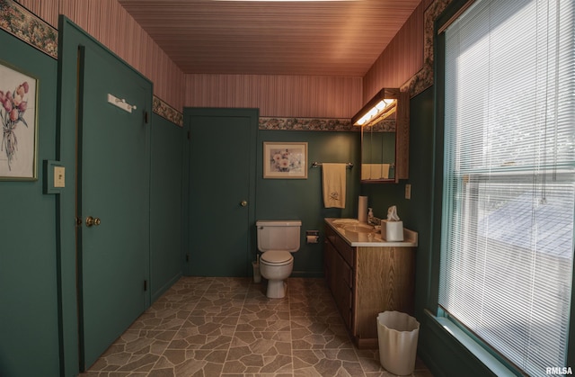 541 10th Ave S, Clinton, IA 52732 - bathroom with vanity, toilet, and wallpapered walls