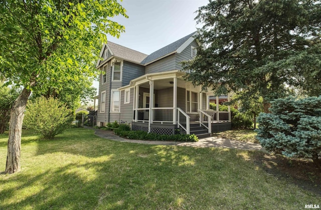 541 10th Ave S, Clinton, IA 52732 - rear view of property featuring a porch, a lawn, and a shingled roof