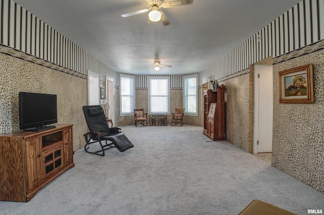 541 10th Ave S, Clinton, IA 52732 - sitting room with wallpapered walls, ceiling fan, and carpet floors