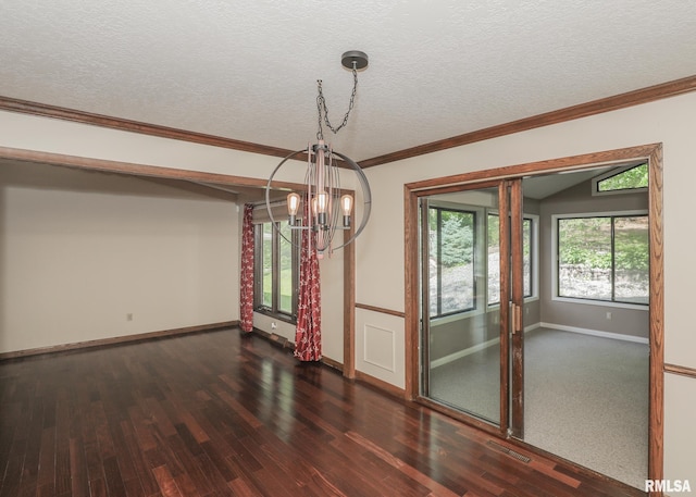 3 Wildwood Trl, Bettendorf, IA 52722 - empty room featuring a chandelier, dark wood-type flooring, baseboards, a textured ceiling, and ornamental molding