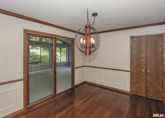 3 Wildwood Trl, Bettendorf, IA 52722 - unfurnished dining area with dark wood-style floors, a chandelier, a wainscoted wall, a textured ceiling, and ornamental molding